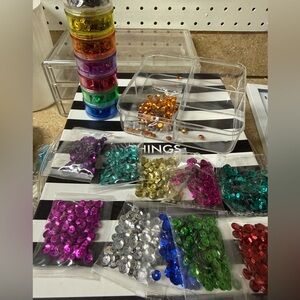 New. Bundle of sequins in assorted colors + acrylic storage containers.